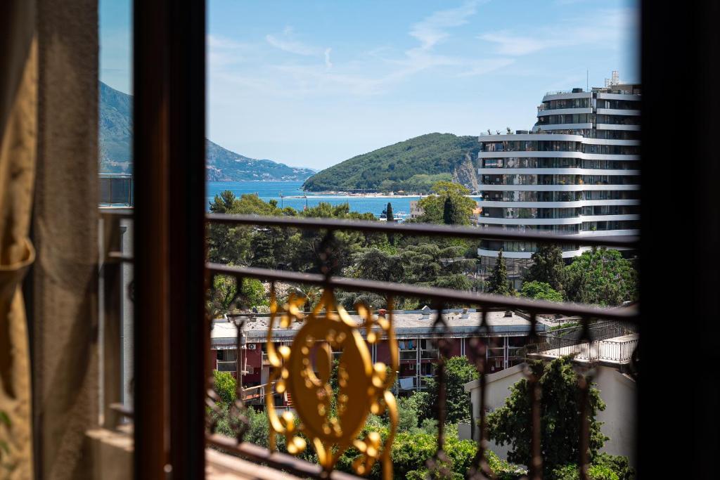 a view from a window of a building with a clock at Hotel Perun in Budva
