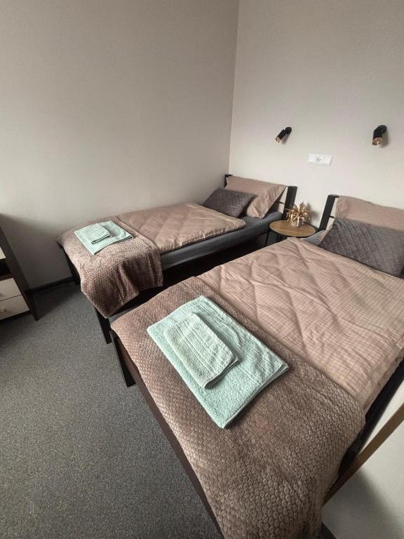 a room with three beds in a room at 208 Apartment Ania in Koszalin