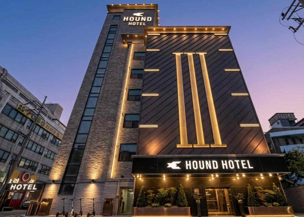 a hotel building with a sign on the front of it at Hound Hotel Incheon Seogu in Incheon