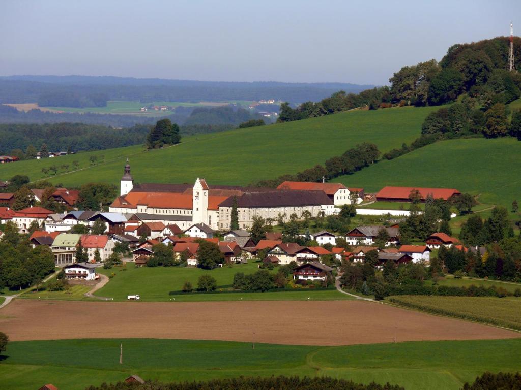 a small town in the middle of a green field at Benediktinerstift Michaelbeuern in Michaelbeuern