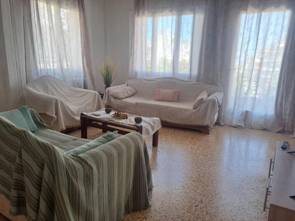 a living room with two chairs and a couch at Aspasia's apartment in Mytilene