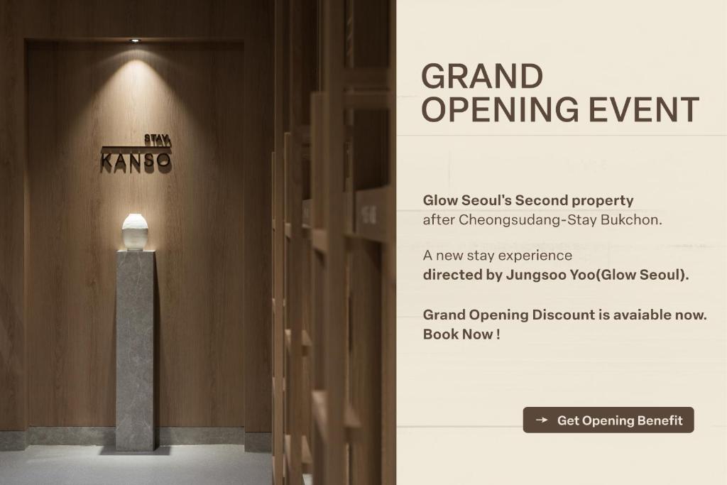 a sign for a grand opening event with a light in a hallway at Kanso Stay Jongno in Seoul