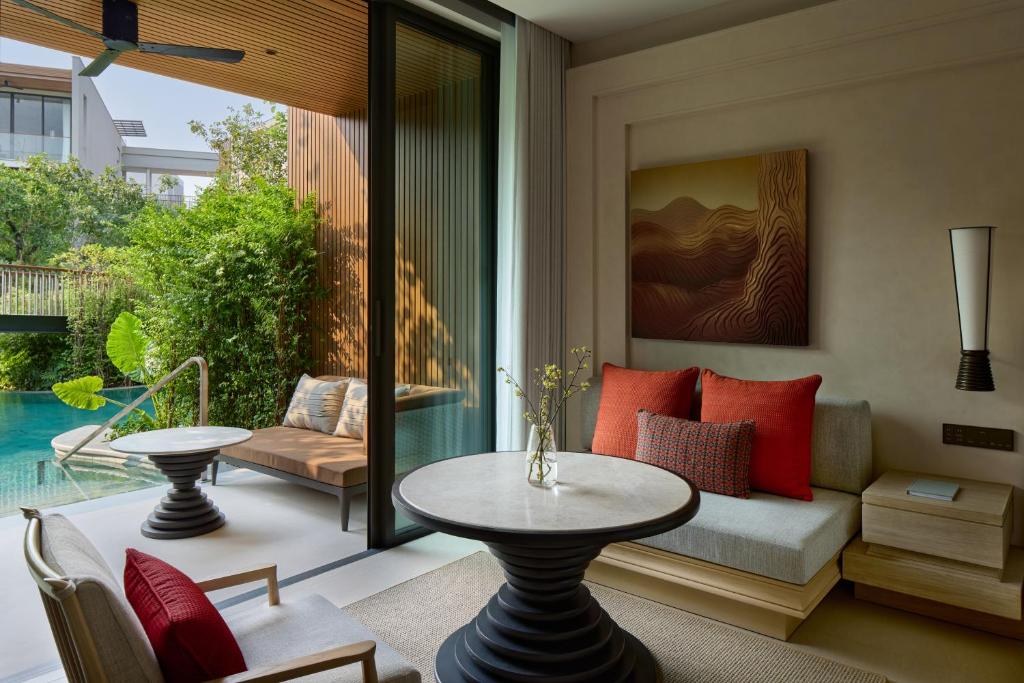 a living room with a couch and a table at THE BARAI HUA HIN - The Unbound Collection by Hyatt in Hua Hin