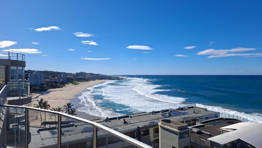 a view of the beach from the balcony of a building at Santorini 402B in Margate