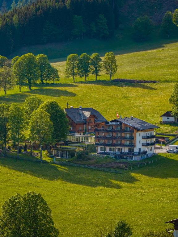 an aerial view of a large house in a field at Hotel Ramsauhof Zimmer Appartement Pool & Wellness in Ramsau am Dachstein