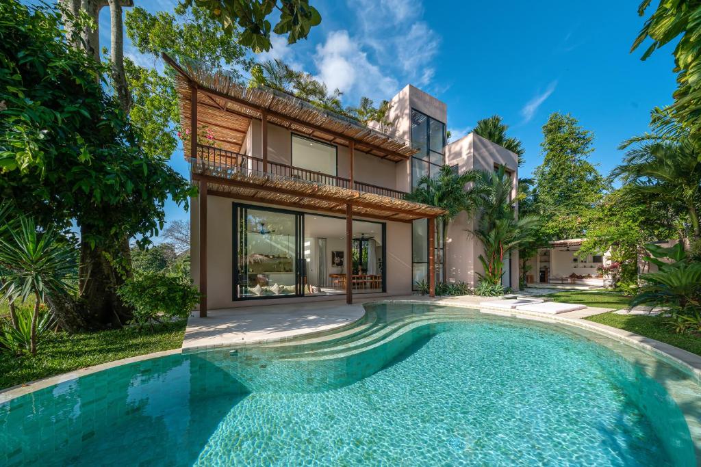 an exterior view of a house with a swimming pool at Sealuna Villas in Tanah Lot
