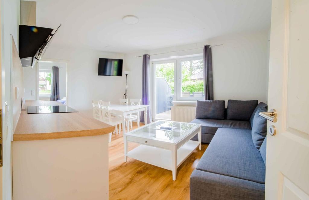 a living room and kitchen with a couch and a table at Schleiblick App 14 in Rabenkirchen-Faulück