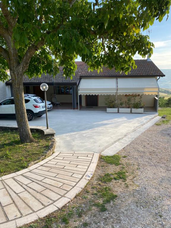 a house with a car parked in the driveway at Bed and Breakfast "POGGIO MARANO" in San Bartolomeo in Galdo