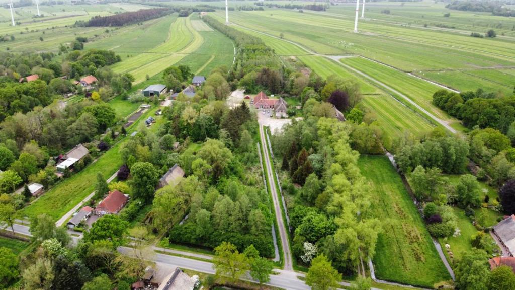 an aerial view of a village with trees and a road at Biohof Holthusen in Hammelwarder Außendeich
