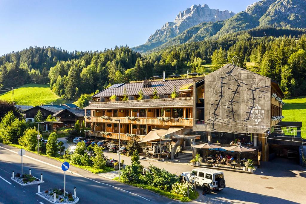 a hotel in the mountains with a road in front of it at mama thresl in Leogang