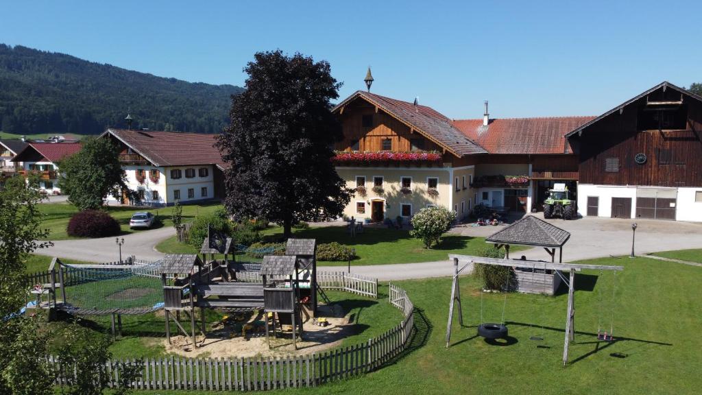 a large building with a playground in front of it at Kinderparadies Bachbauer in Mondsee
