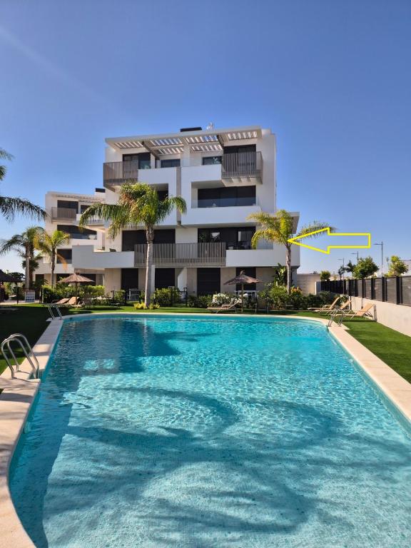 a large swimming pool in front of a building at Casa Mirapa in Torre-Pacheco