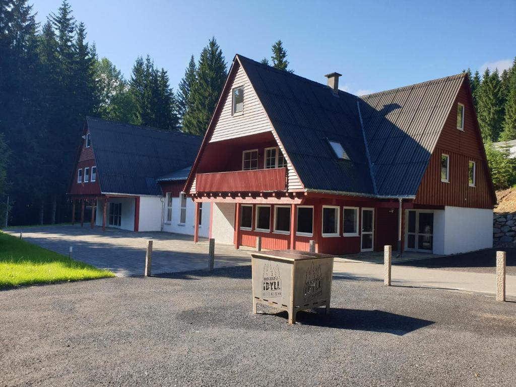 a large red and white building with a black roof at Sauberghaus Wohnung 3 in Breitenbrunn