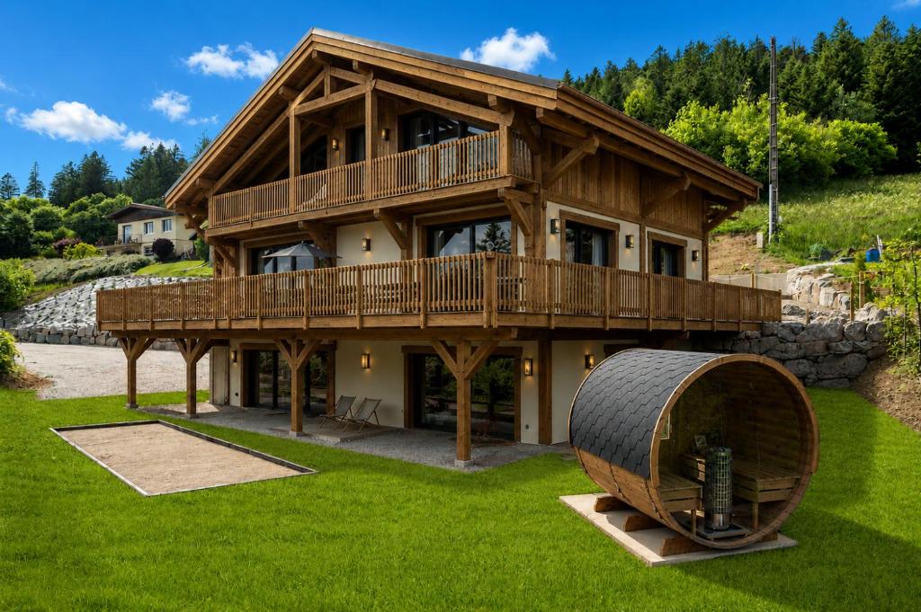 a large wooden house with a large tire in front of it at Chalet Le Cocon des Marmottes Vue Imprenable Confort Haut de Gamme & Services sur Mesure in Gérardmer