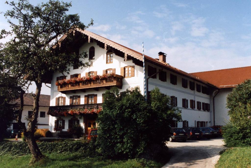 a large white building with a balcony on it at Schneiderhof in Rimsting