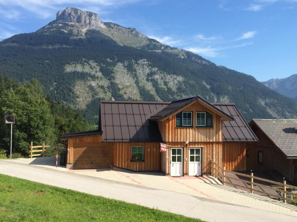 a wooden house with a mountain in the background at Apartment Altaussee in Altaussee