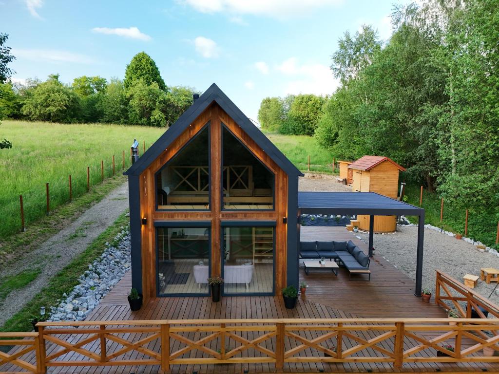 a house with a deck and a fence at Gawra Pogórze in Jawornik Polski