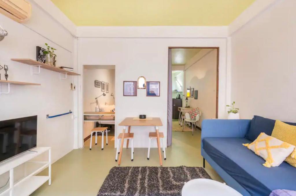 a living room with a blue couch and a table at Bang Chak 1 Bedroom apartment in Bangkok