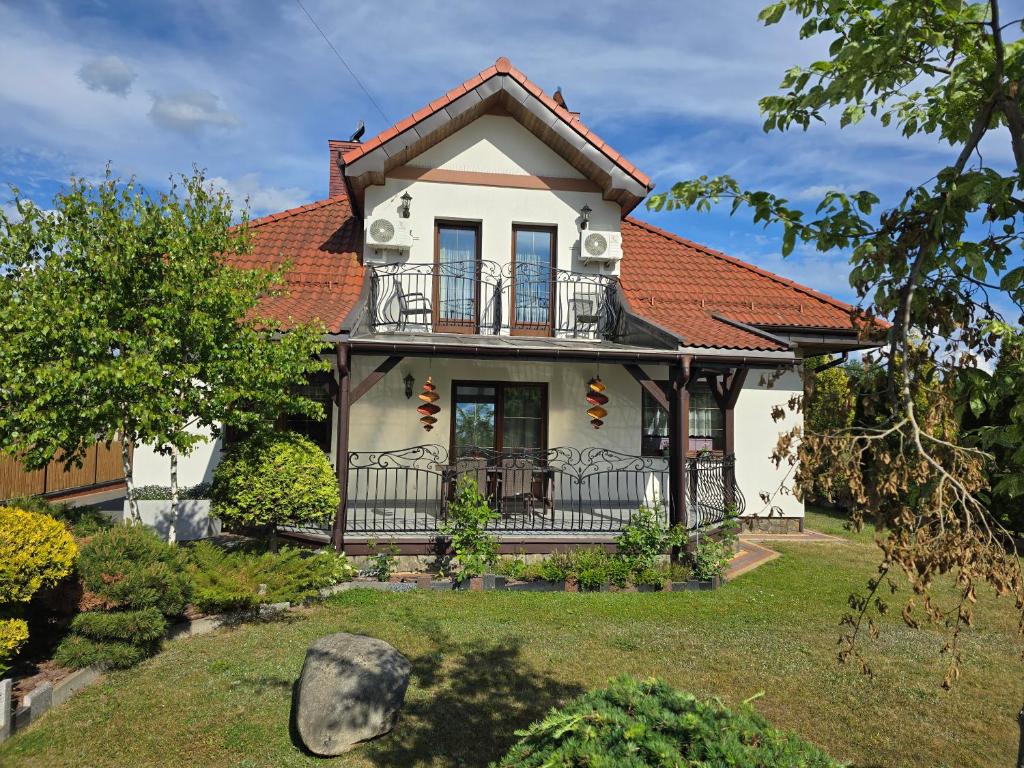 a white house with a red roof at Białowieski Raj in Białowieża