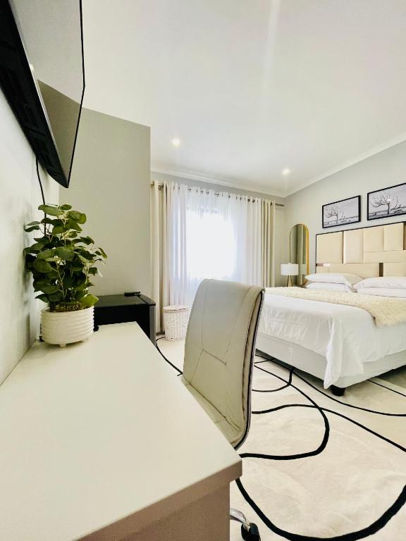 a bedroom with two beds and a tv in it at Cozy and Warm-Private Queen Bedroom with Private Bathroom & shared Kitchen& Lounge in Parklands