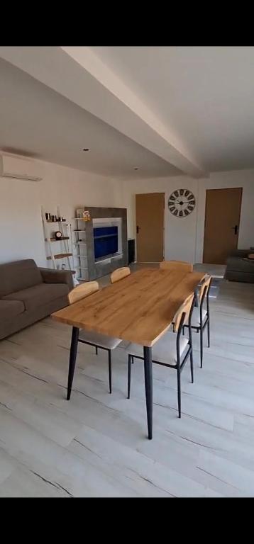 a large wooden table in a living room at Chez JP & NATH in Alcossebre