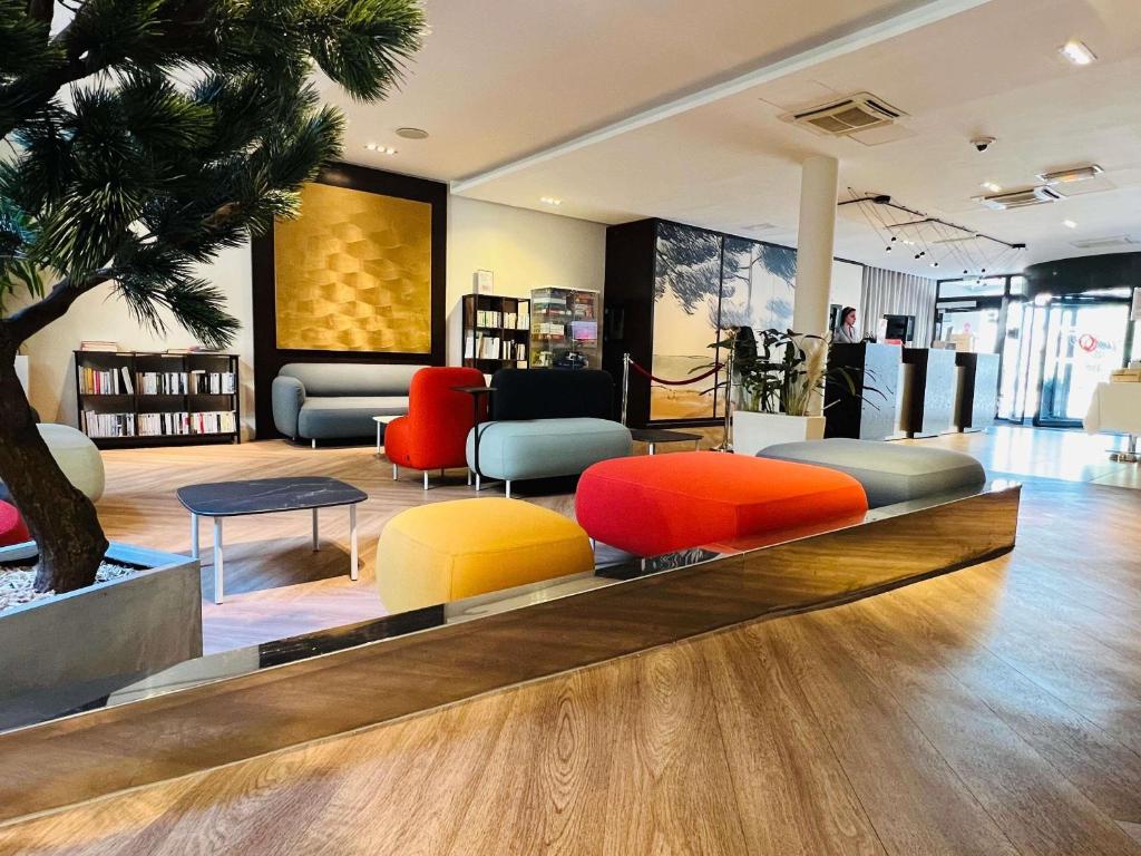 a store with colorful chairs and tables in a room at Aparthotel Adagio Marseille Timone in Marseille