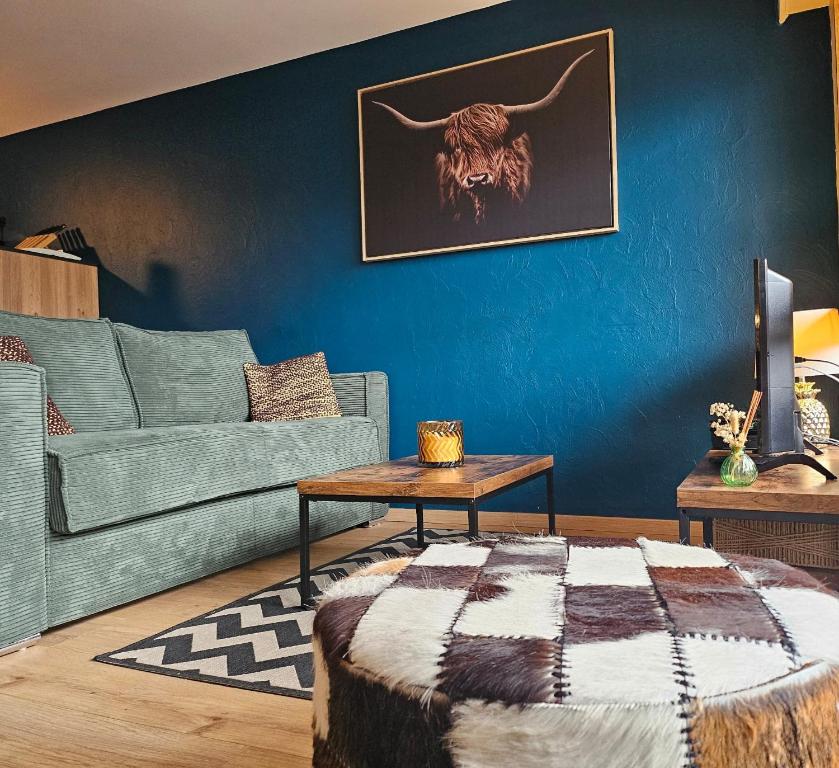a living room with a couch and a table at Le Haut du Rosay in Sallanches