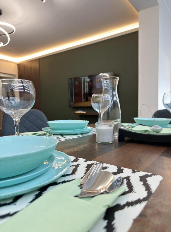 a table with plates and utensils on top of it at Top Centre Apartment 5 mins to beach in Burgas