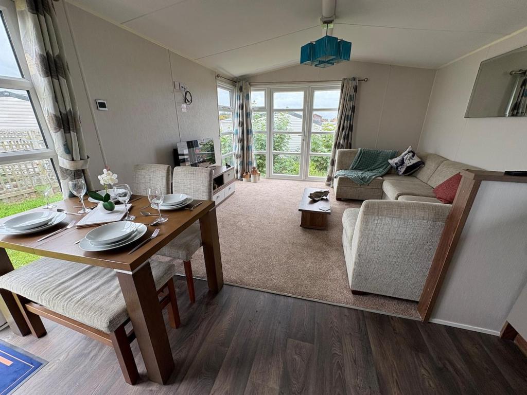a living room with a table and a couch at Skyline in Lossiemouth