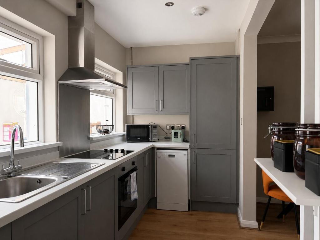 a kitchen with a sink and a counter top at Llantarnam House by Tŷ SA in Cardiff