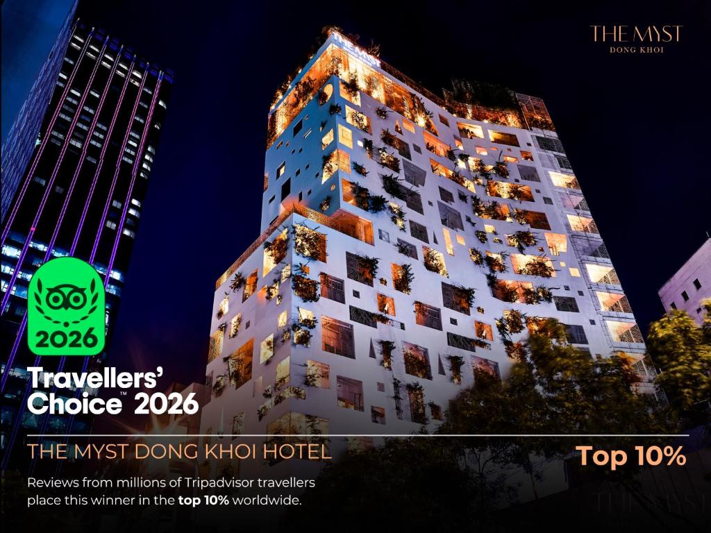 a tall building is lit up at night at The Myst Dong Khoi in Ho Chi Minh City