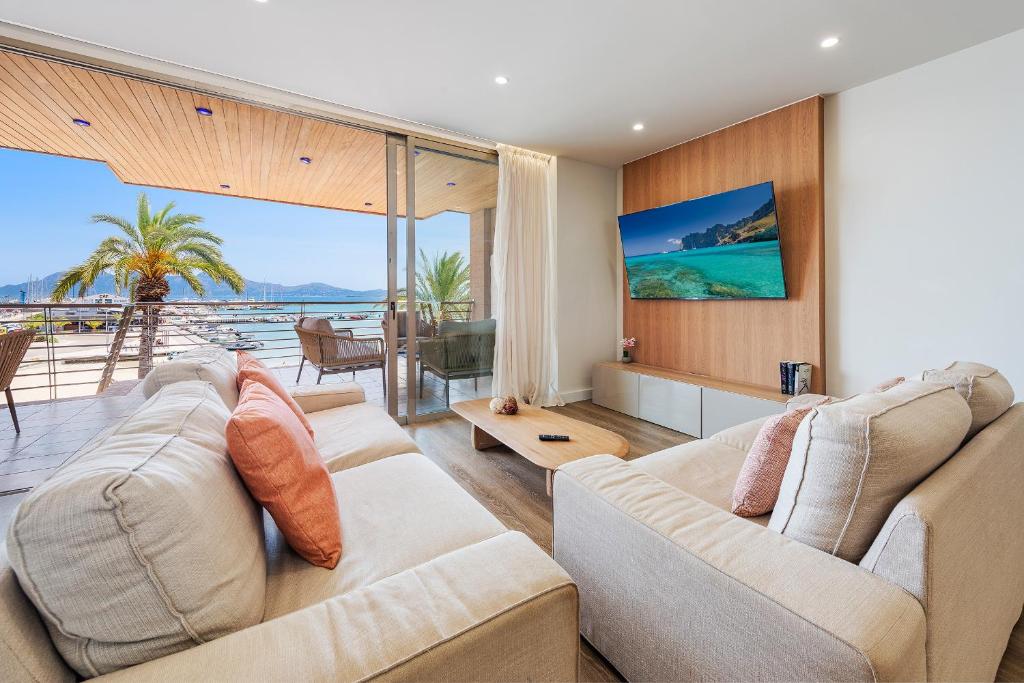 a living room with two couches and a view of the ocean at Apartment Vistamar II in Port de Pollensa