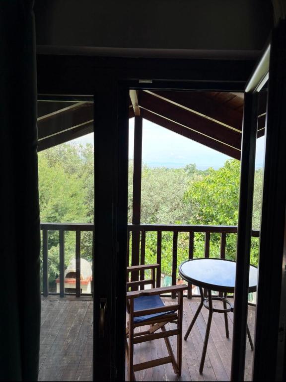 a view of a balcony with a table and chairs at Azure Escape Villa in Platamonas