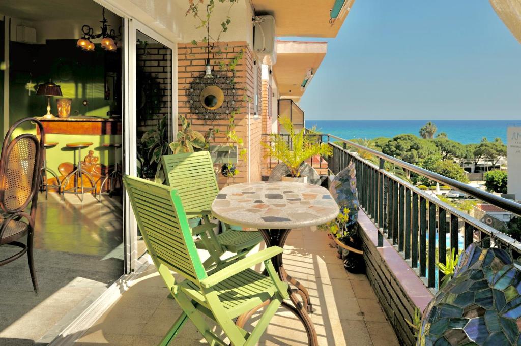 a patio with a table and chairs on a balcony at Seaview Beach Residence Malgrat de Mar in Malgrat de Mar