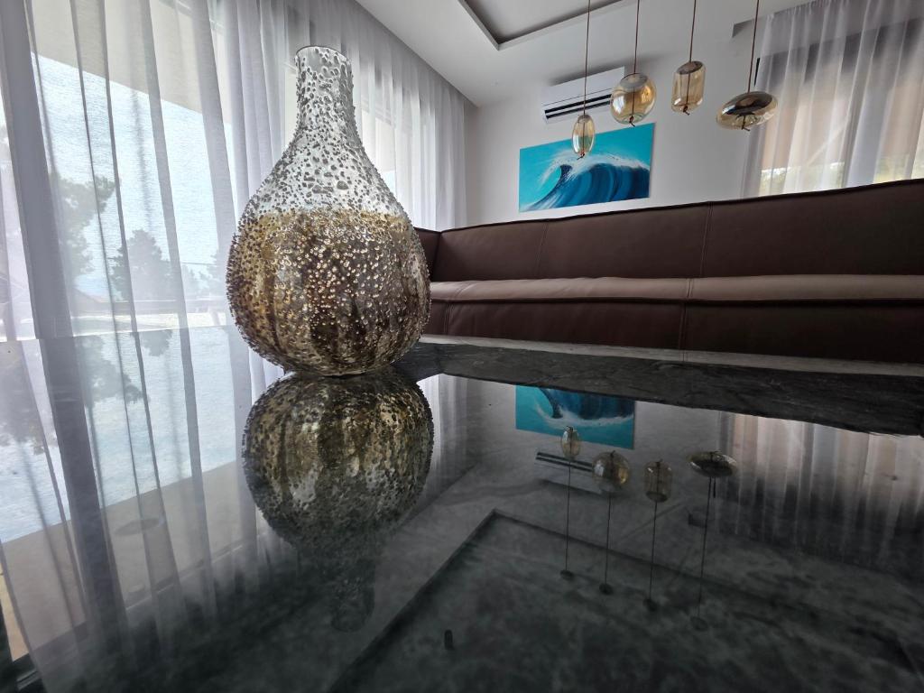 a living room with a large glass vase on the floor at Villa Tedi in Podaca