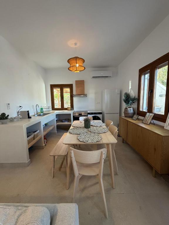 a kitchen and dining room with a table and chairs at Patmian charm 2 bedrooms in Skala
