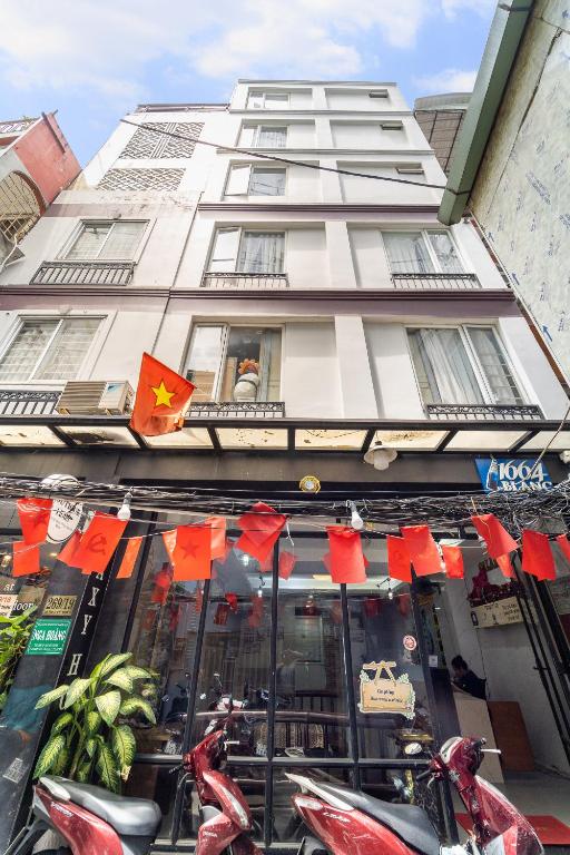 a store with motorcycles parked in front of a building at Ngân Hà Bouitque Apartment-Hotel in Ho Chi Minh City