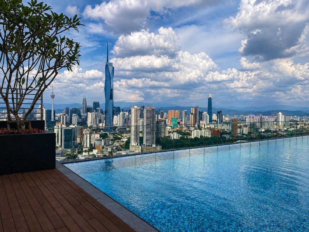 a swimming pool with a view of the city at Riveria City by Nomadnest in Kuala Lumpur