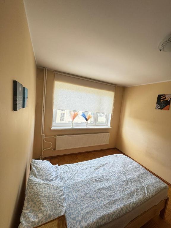 a small bedroom with a bed and a window at Joy Haven in Tallinn