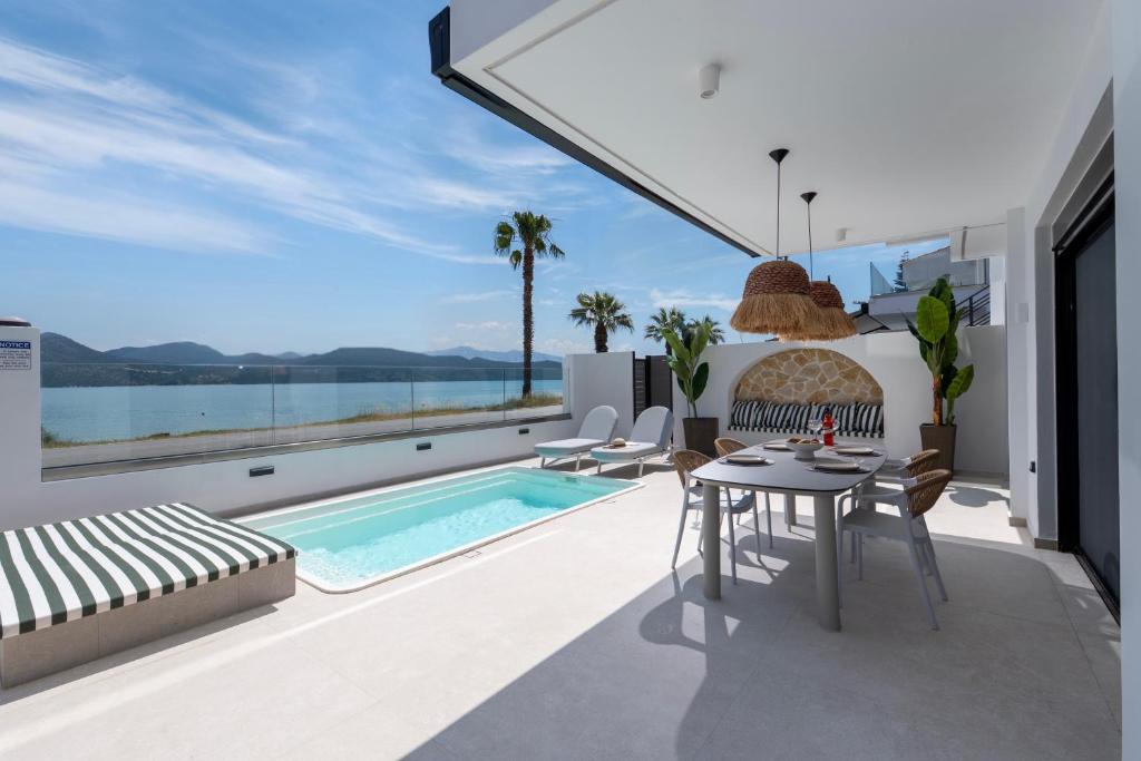 a villa with a swimming pool and a patio at Ciel Seafront Suites - Lefkada in Lygia