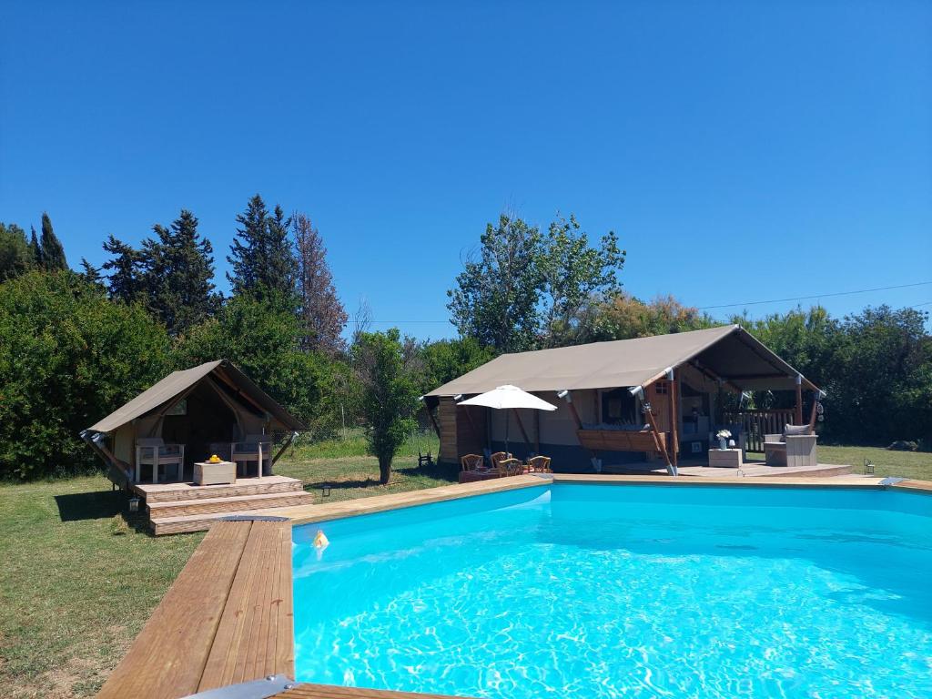 a villa with a swimming pool and a gazebo at casa la luna glamping in Alhaurín el Grande