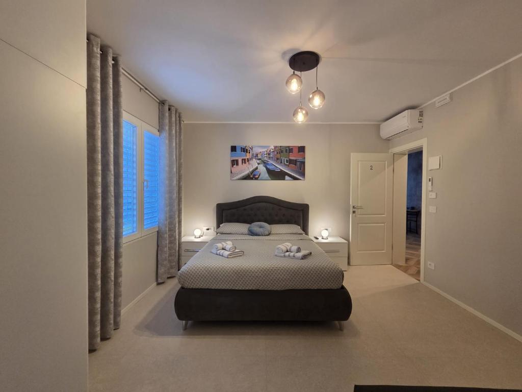 a bedroom with a bed with two pillows on it at Aria venice rooms in Tessera