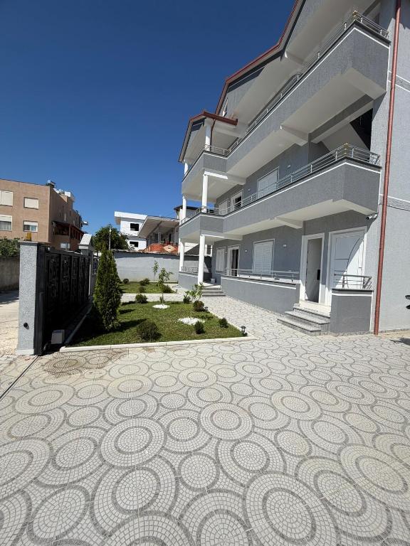 a building with a pattern on the ground at Alison Guest House in Durrës