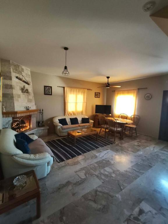 a living room with a couch and a table at Kalymnos Sea View Villa in Kalymnos