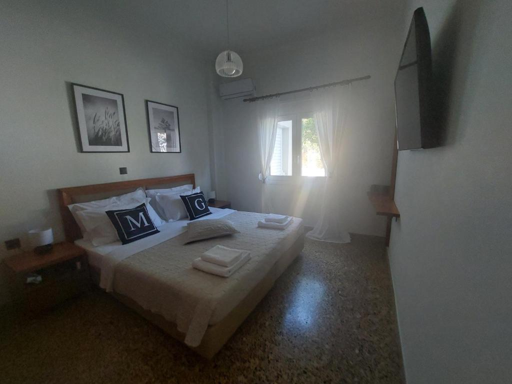 a bedroom with a bed with towels on it at MG elounda apt in Elounda