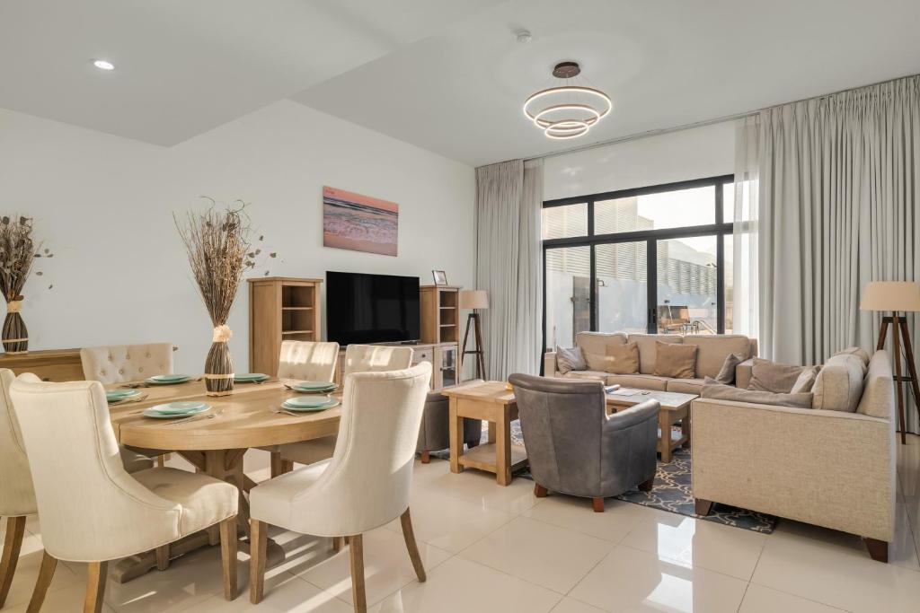 a living room with a dining table and a couch at 3BR villa BBQ Pool and Maidroom near diving center Dana Island in Sharm