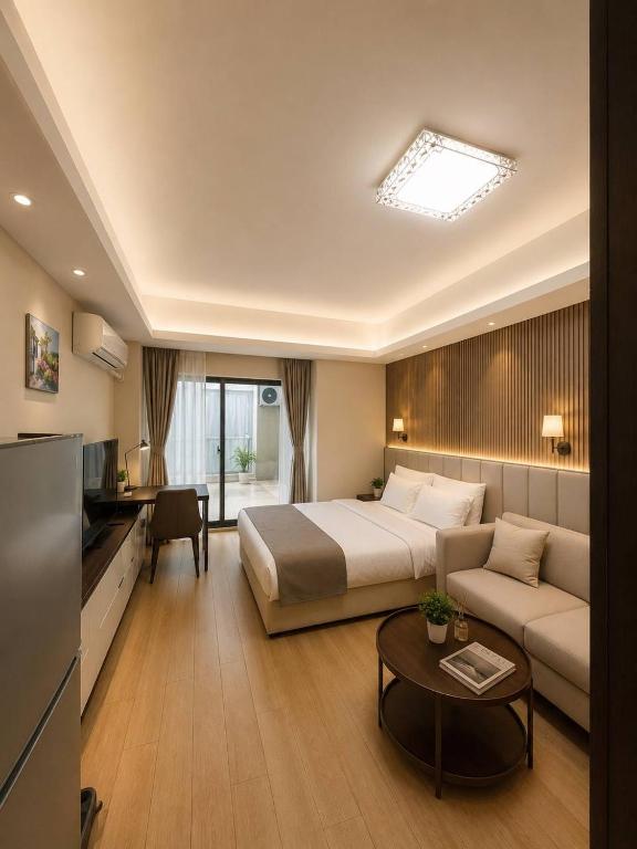 a hotel room with a bed and a couch at Tian Yue Hotel in Phnom Penh