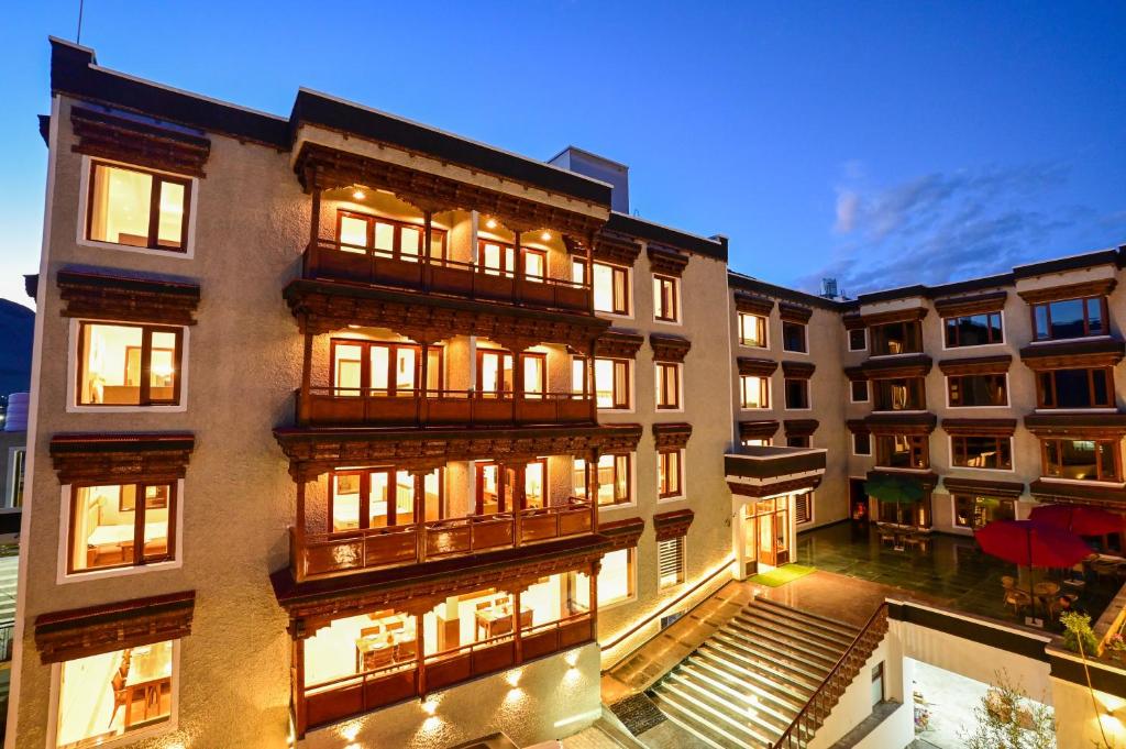 a tall building with many windows and lights at Hotel Aero Ladakh in Leh