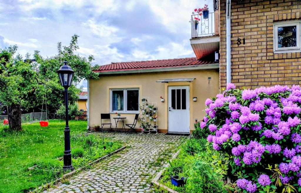 a house with pink flowers in front of it at Apple Tree Garden House in Örebro
