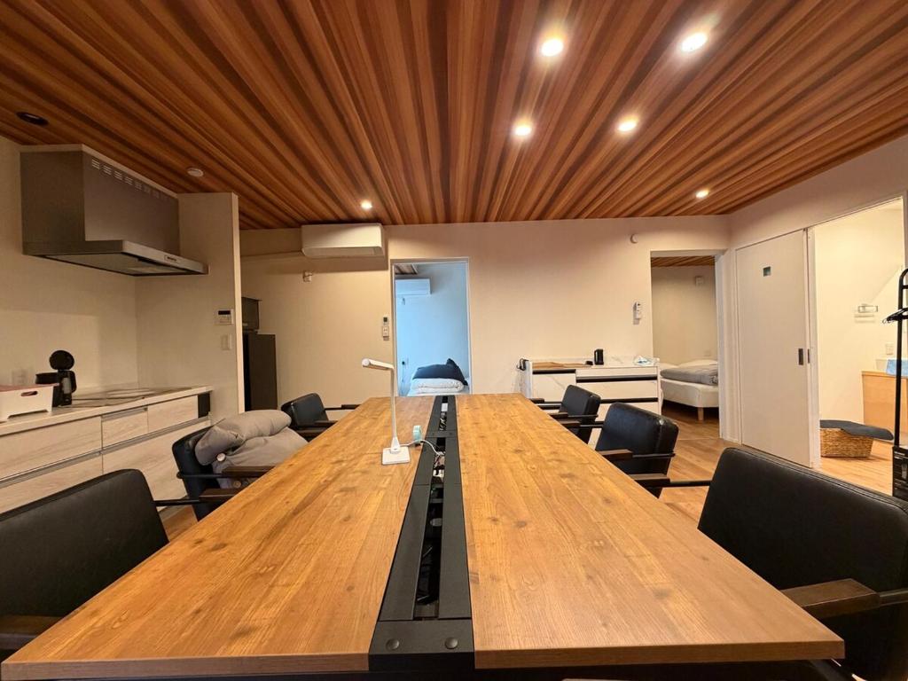 a conference room with a long wooden table and chairs at テラスKawazu in Kawazu
